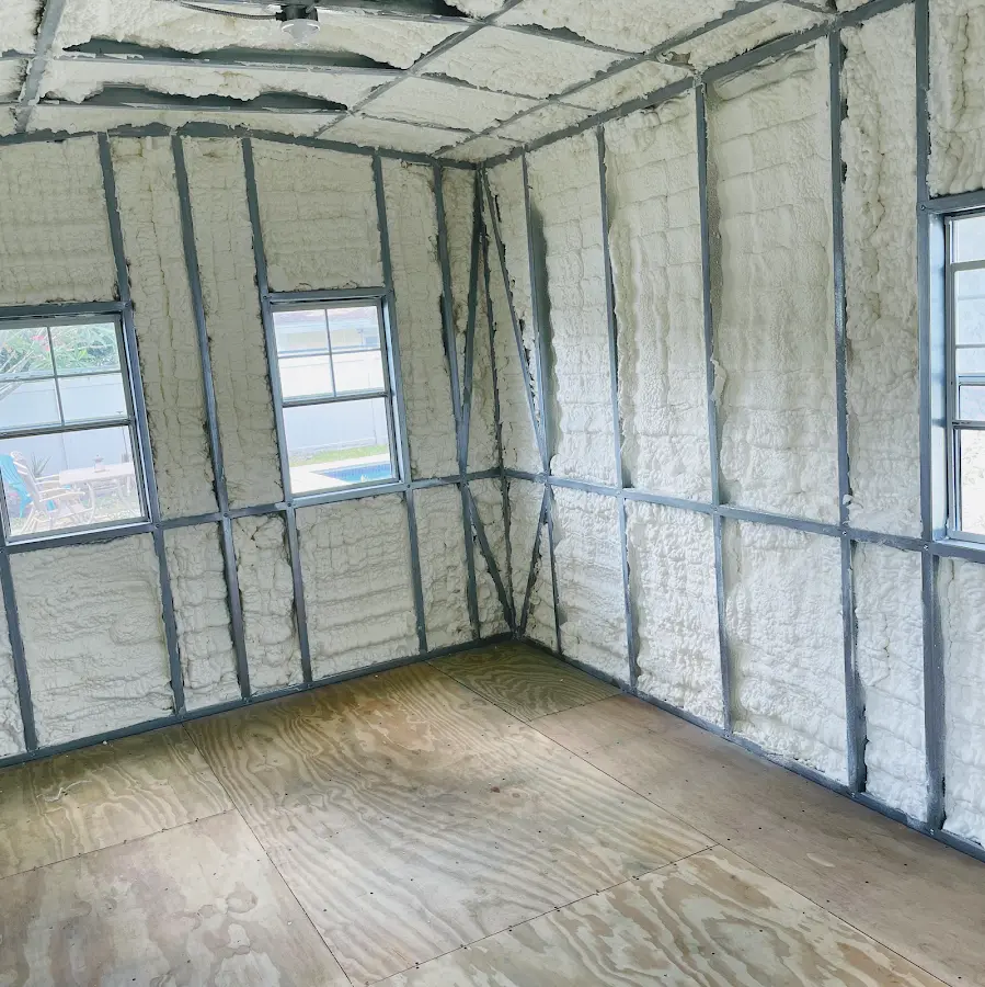 Closed-cell spray foam insulation applied to wall cavities in a residential project in Brighton